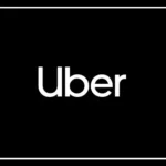 Uber driver riding a motorcycle on an Indian city road