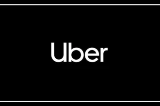Uber driver riding a motorcycle on an Indian city road